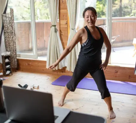 A woman exercising in the comfort of her home.
